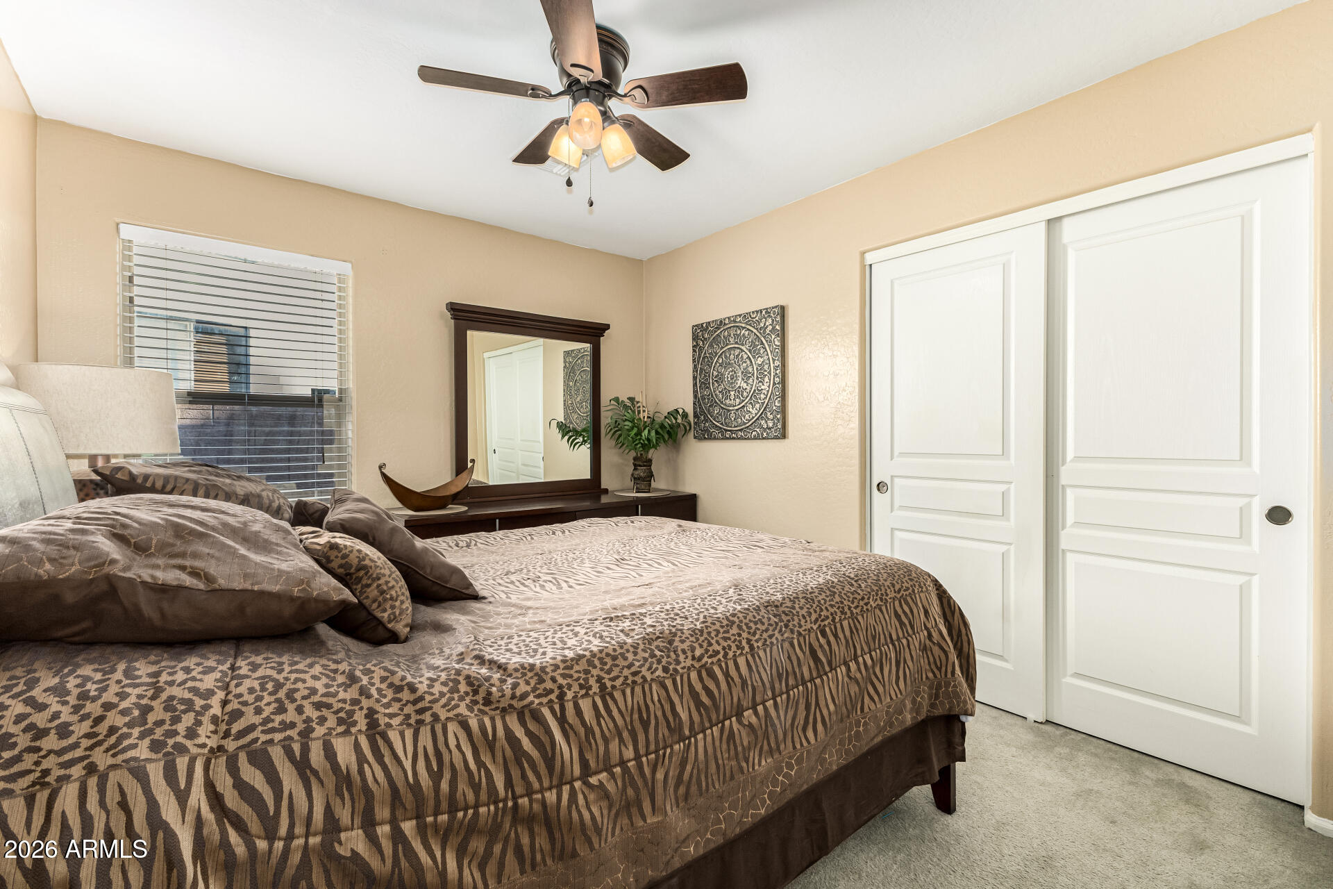 45144 West Desert Garden Road Maricopa, AZ 85139 - Photo 31 of 52 a bedroom with a large bed and a chandelier