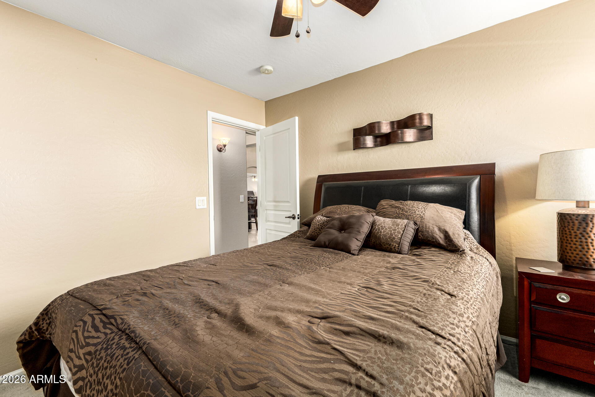 45144 West Desert Garden Road Maricopa, AZ 85139 - Photo 32 of 52 a bedroom with a bed and a chandelier