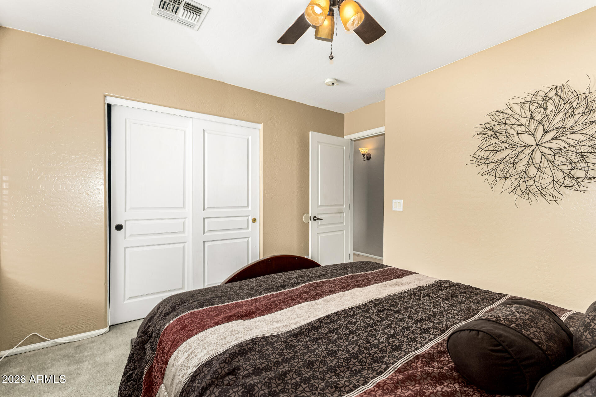 45144 West Desert Garden Road Maricopa, AZ 85139 - Photo 34 of 52 a bedroom with a bed and a chandelier