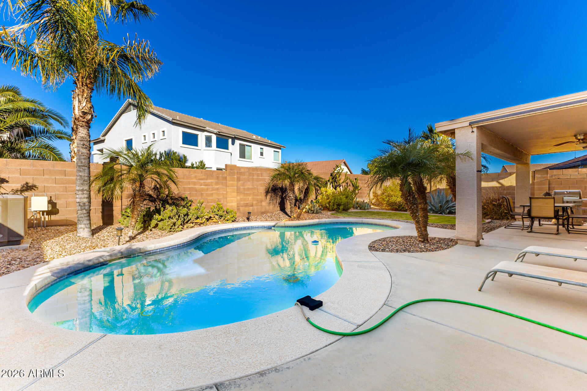45144 West Desert Garden Road Maricopa, AZ 85139 - Photo 36 of 52 a view of a swimming pool with a patio