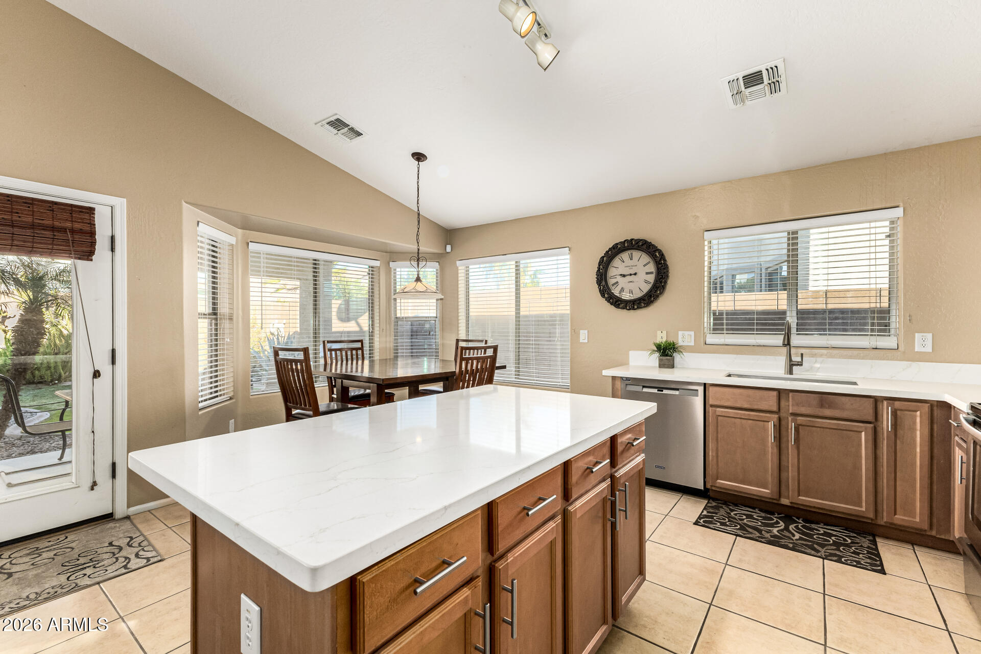 45144 West Desert Garden Road Maricopa, AZ 85139 - Photo 7 of 52 a kitchen with granite countertop a sink a stove top oven a counter space and cabinets