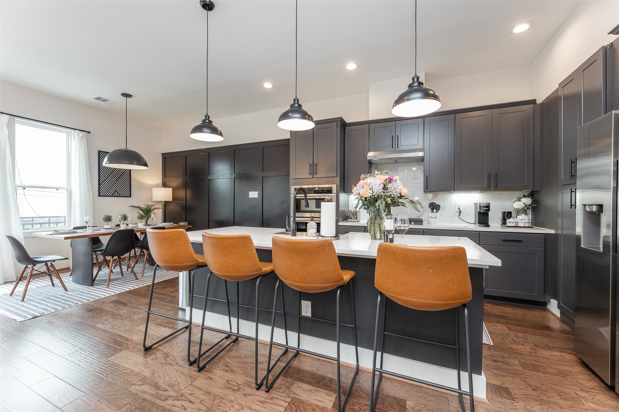 605 Middle Street Houston, TX 77003 - Photo 2 of 33 a kitchen with stainless steel appliances kitchen island granite countertop a table chairs and a refrigerator