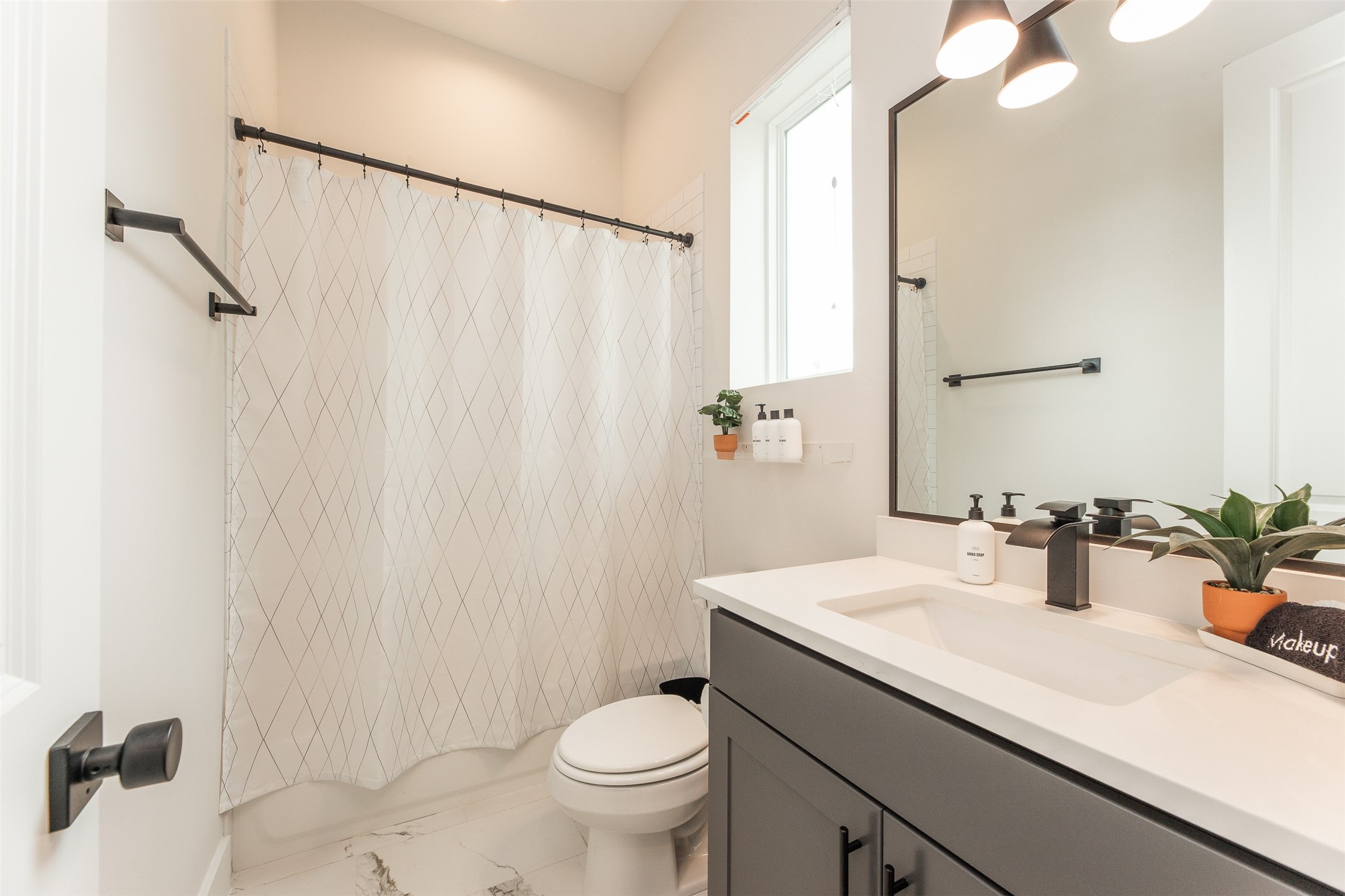 605 Middle Street Houston, TX 77003 - Photo 31 of 33 a bathroom with a sink a toilet and shower curtain