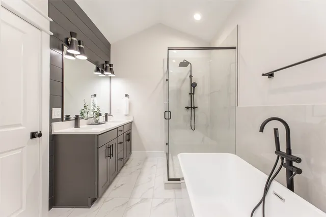 a bathroom with a double vanity sink mirror and shower