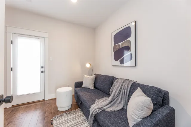 a living room with furniture and wooden floor