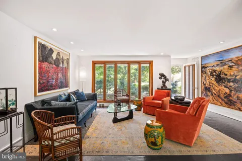a living room with furniture and a floor to ceiling window