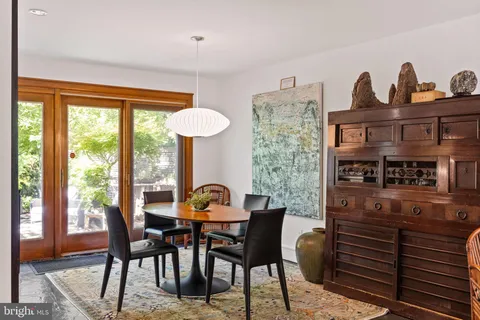 a dining room with furniture and window