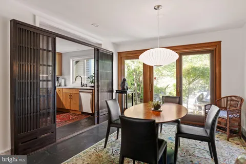 a dining room with furniture a chandelier and wooden floor