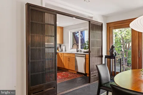 a dining room with furniture and a window