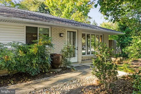 a view of a house with potted plants