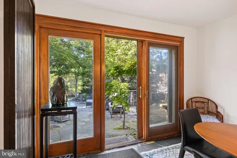 a view of a patio with couches table and chairs and potted plants