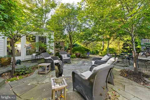 a view of a patio with table and chairs and potted plants