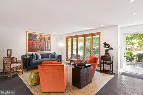 a living room with furniture and large windows