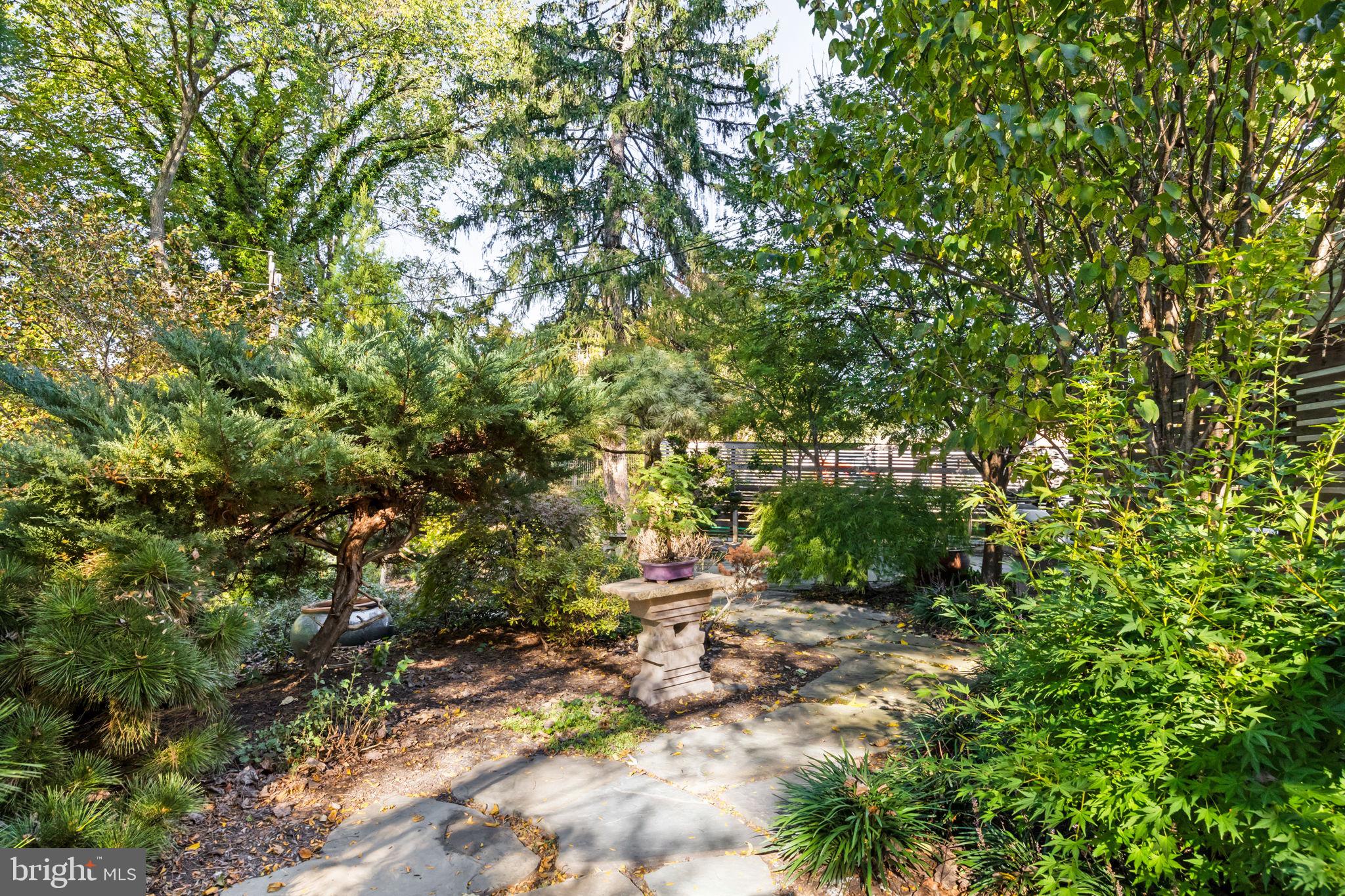 303 Glenway Road Glenside, PA 19038 - Photo 43 of 56 a backyard of a house with lots of green space and a fountain