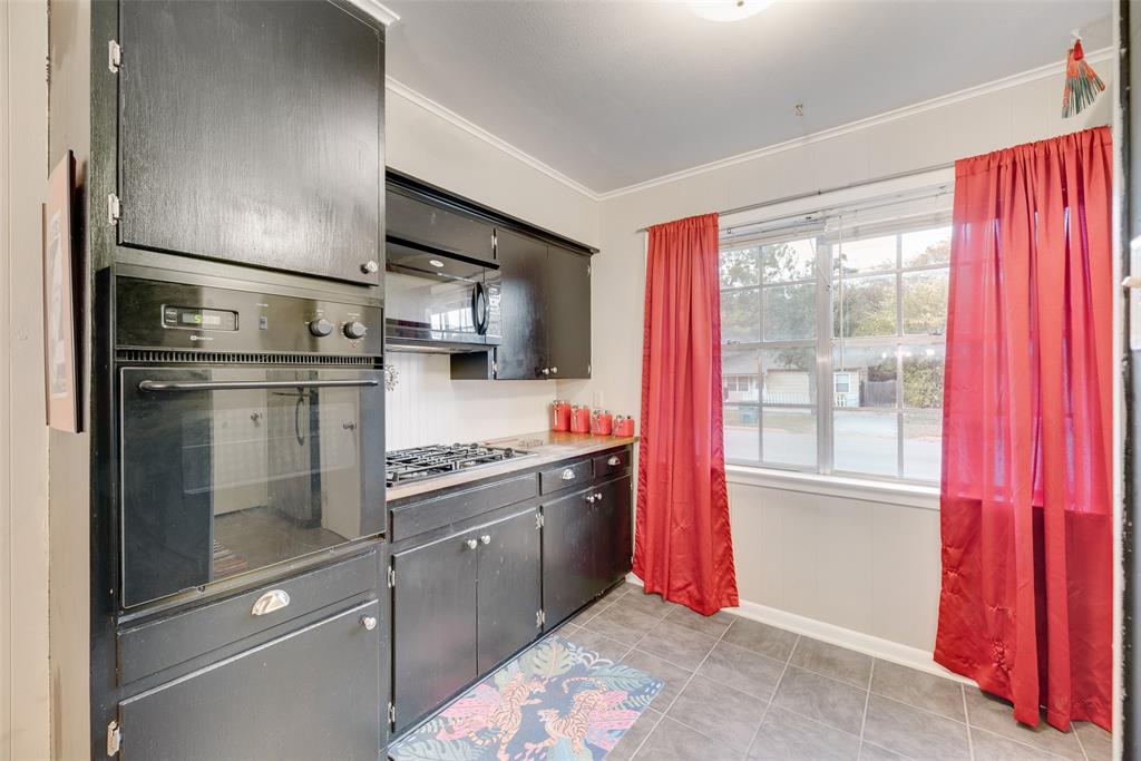 419 Marietta Street Denton, TX 76201 - Photo 12 of 20 a kitchen with stainless steel appliances granite countertop a refrigerator and a sink