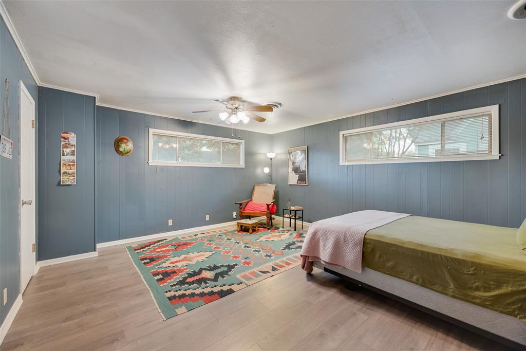 419 Marietta Street Denton, TX 76201 - Photo 15 of 20 a bed room with a bed and painting on the wall