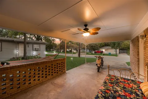 a view of a porch with furniture and yard