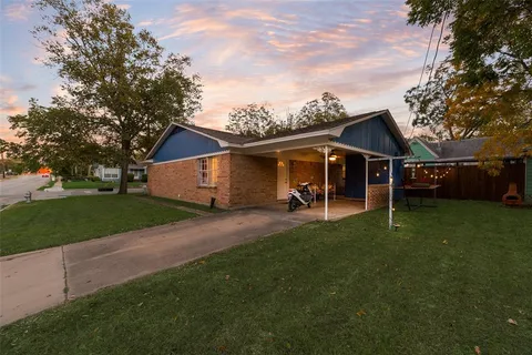 a view of a house with a yard and sitting area