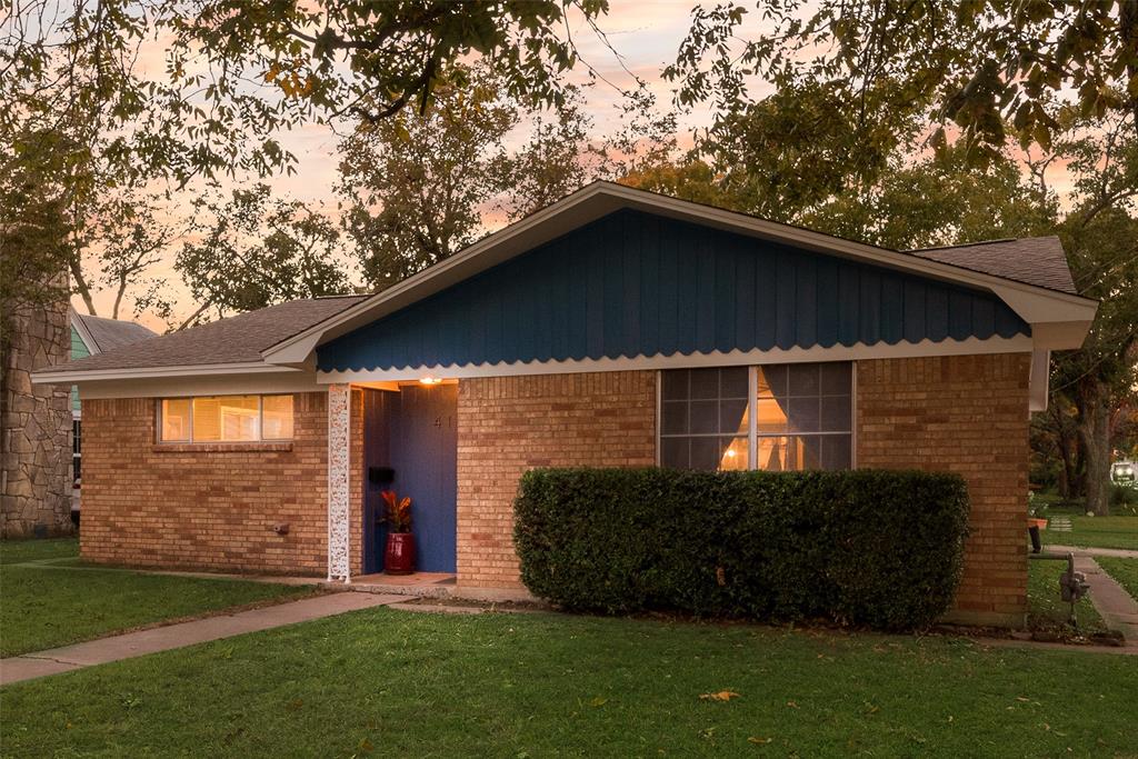 419 Marietta Street Denton, TX 76201 - Photo 2 of 20 a yellow house with tall trees in the background