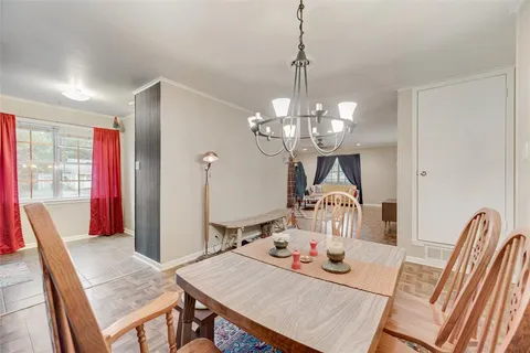 a view of a dining room with furniture wooden floor and chandelier