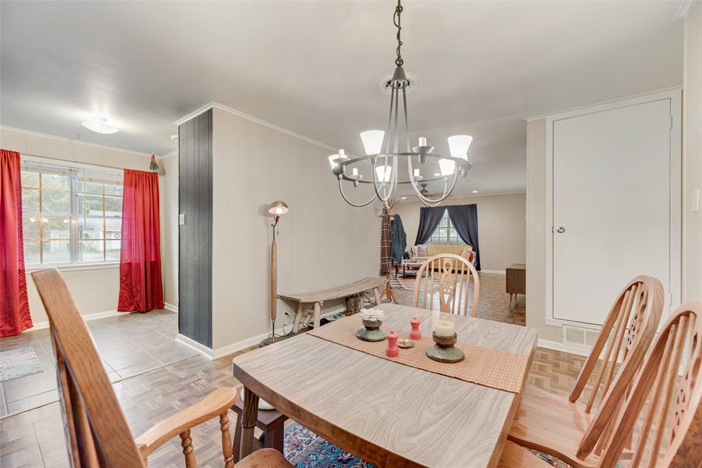 419 Marietta Street Denton, TX 76201 - Photo 9 of 20 a view of a dining room with furniture wooden floor and chandelier