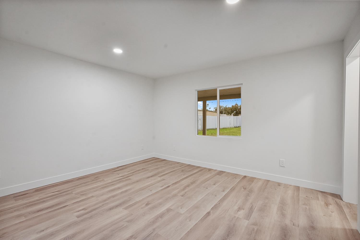 1715 Dallas Street Modesto, CA 95358 - Photo 18 of 35 wooden floor in an empty room with a window