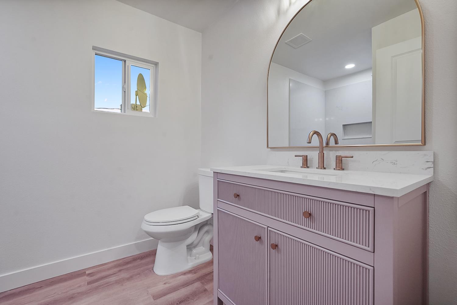 1715 Dallas Street Modesto, CA 95358 - Photo 23 of 35 a bathroom with a toilet sink and mirror