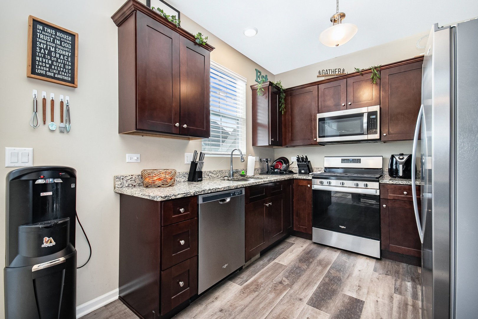 273 Timber Ridge Court Joliet, IL 60431 - Photo 5 of 14 a kitchen with granite countertop a refrigerator stove and microwave