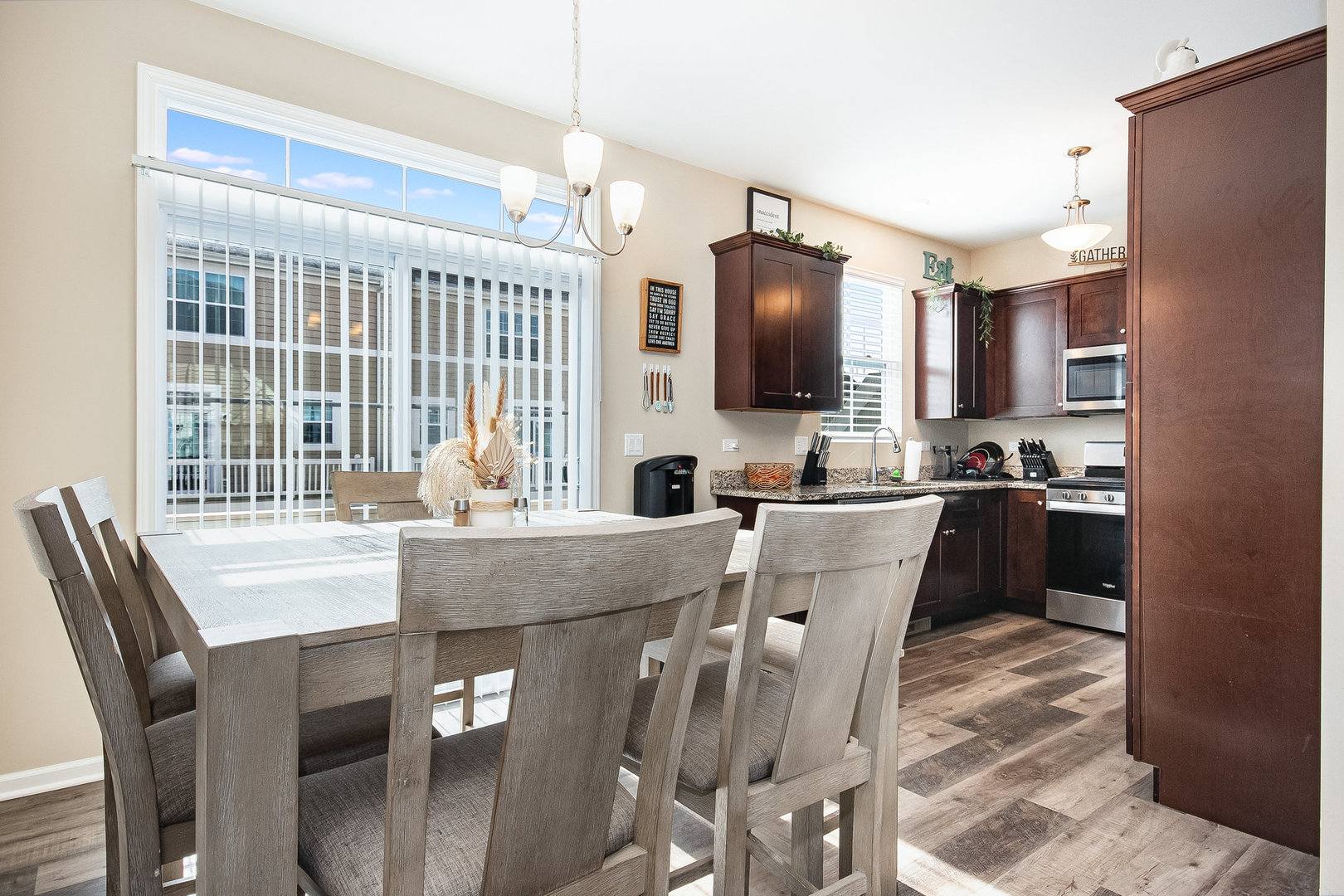 273 Timber Ridge Court Joliet, IL 60431 - Photo 6 of 14 a dining table with chairs and kitchen view