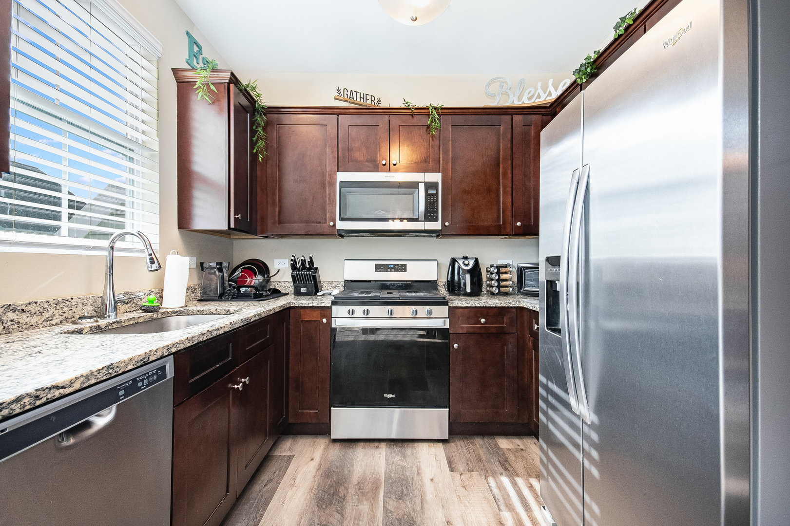 273 Timber Ridge Court Joliet, IL 60431 - Photo 7 of 14 a kitchen with a sink stove and refrigerator