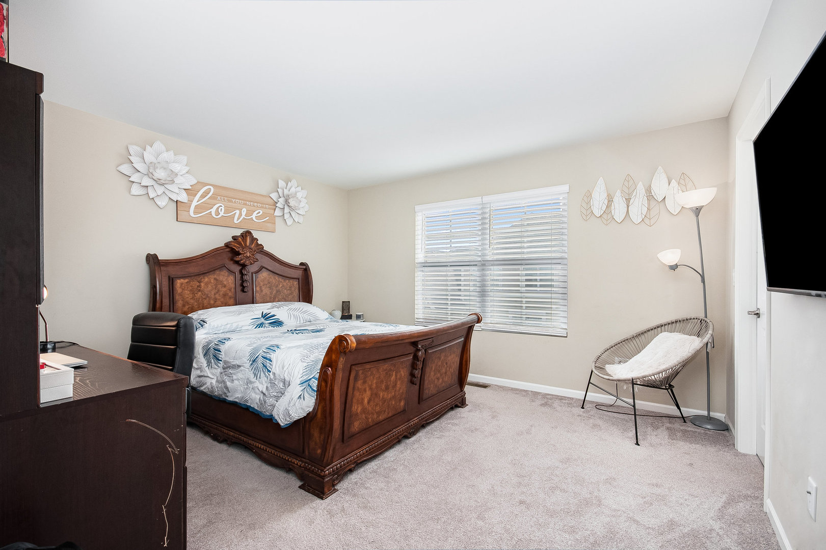 273 Timber Ridge Court Joliet, IL 60431 - Photo 9 of 14 a bedroom with a bed chair and a flat screen tv