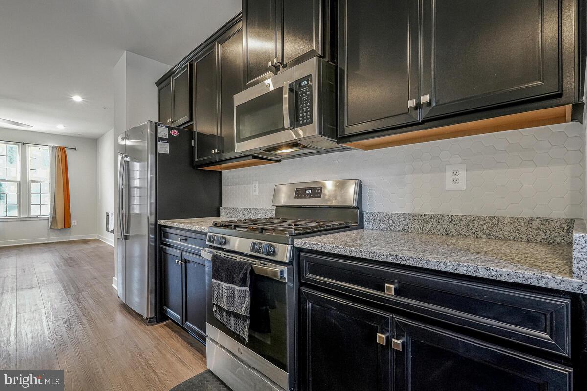 14934 Ring House Road Brandywine, MD 20613 - Photo 12 of 34 a kitchen with granite countertop stainless steel appliances and wooden cabinets