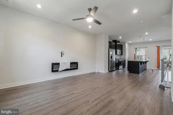 a view of kitchen and hall with wooden floor