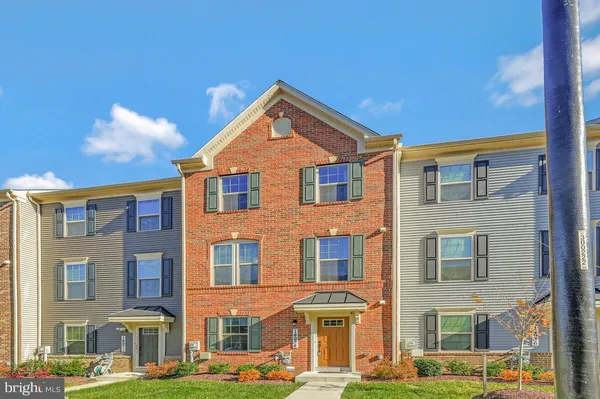 a front view of a residential apartment building with a yard