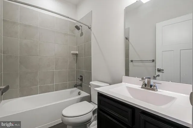 a bathroom with a sink a toilet and a bathtub