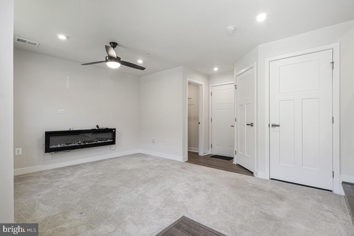 14934 Ring House Road Brandywine, MD 20613 - Photo 7 of 34 an empty room with chandelier fan and windows