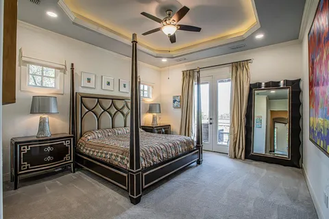 a bedroom with a bed and a chandelier