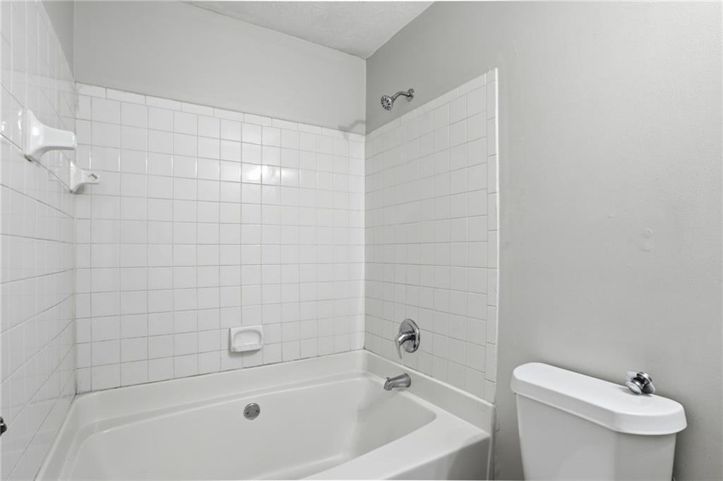 5855 Crescent Ridge Court Lithonia, GA 30058 - Photo 34 of 46 a bathroom with a bathtub and toilet