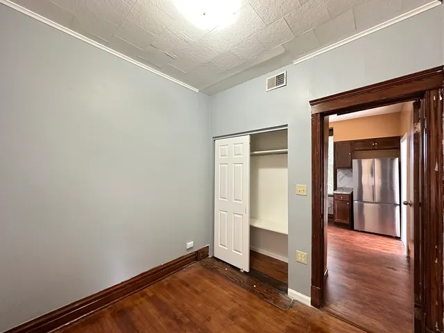 a view of an empty room with wooden floor