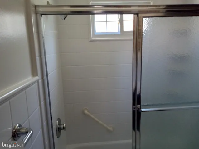 a bathroom with a glass shower door