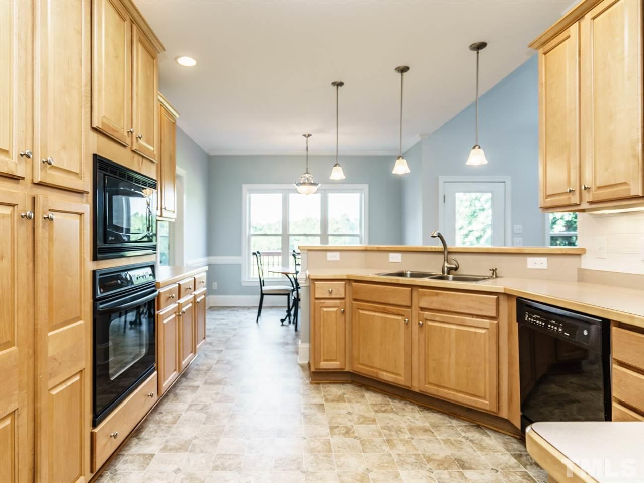 95 Rand Road Raleigh, NC 27603 - Photo 5 of 25 a large kitchen with stainless steel appliances granite countertop a sink and cabinets