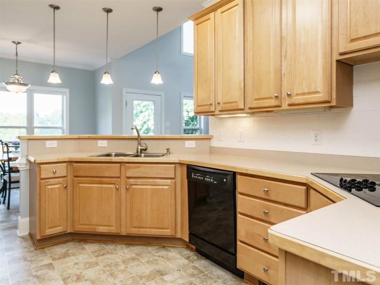 95 Rand Road Raleigh, NC 27603 - Photo 6 of 25 a kitchen with stainless steel appliances granite countertop a sink a stove and cabinets