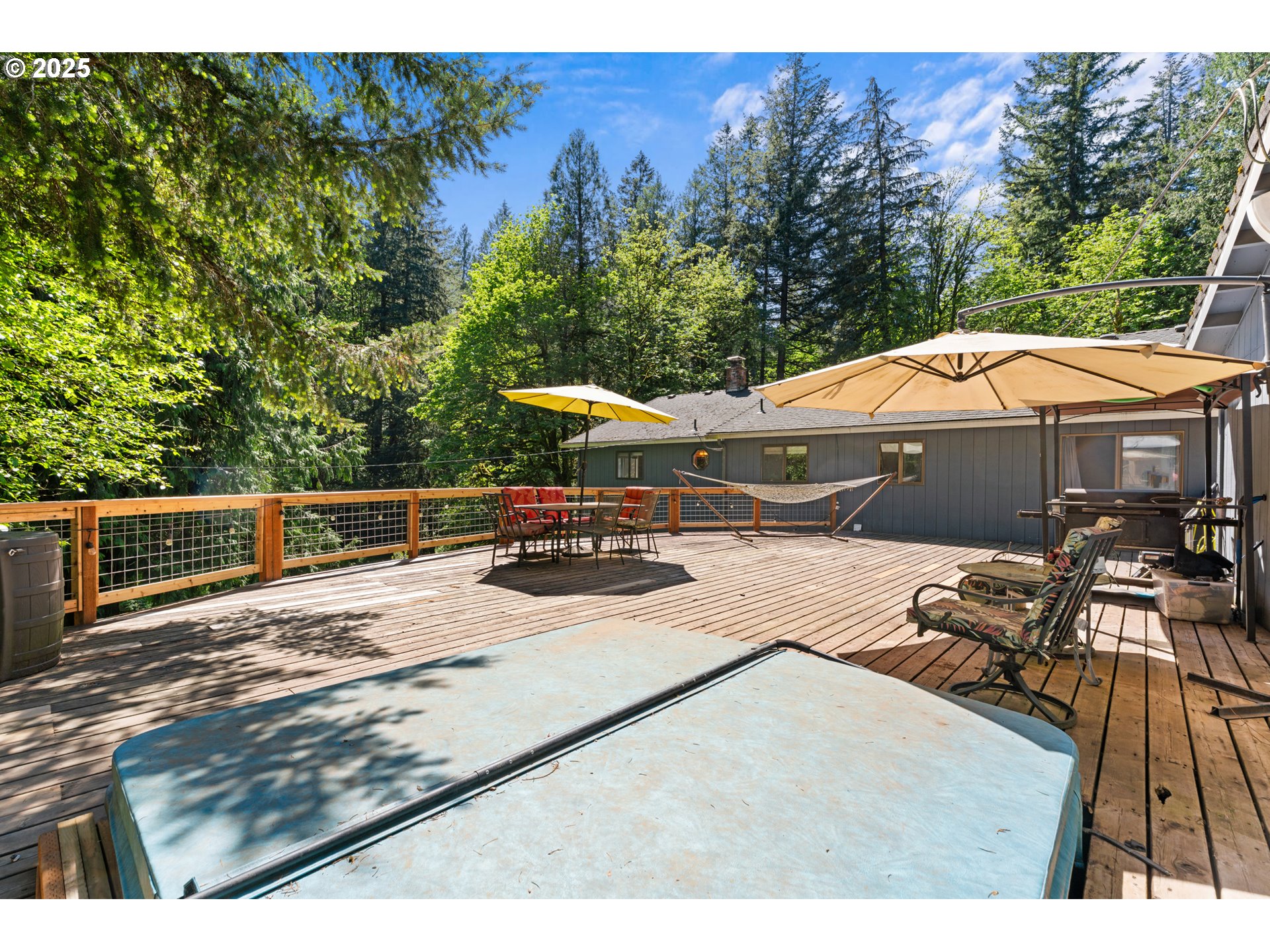 35650 Southeast Barnum Road Sandy, OR 97055 - Photo 6 of 35 a view of a roof deck with couches chairs under an umbrella with a small yard