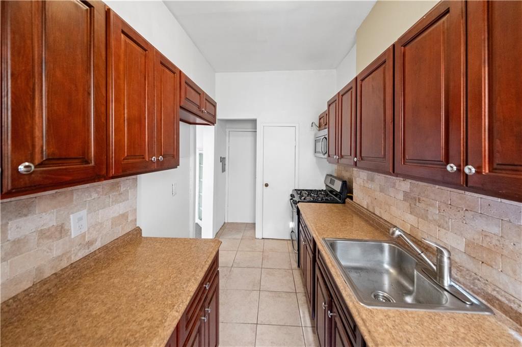 968 St Johns Place Brooklyn, NY 11213 - Photo 15 of 20 a kitchen with a sink and cabinets