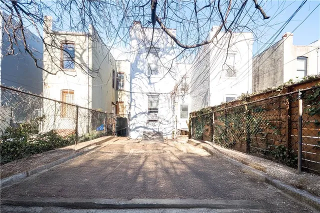 a view of a yard with wooden fence