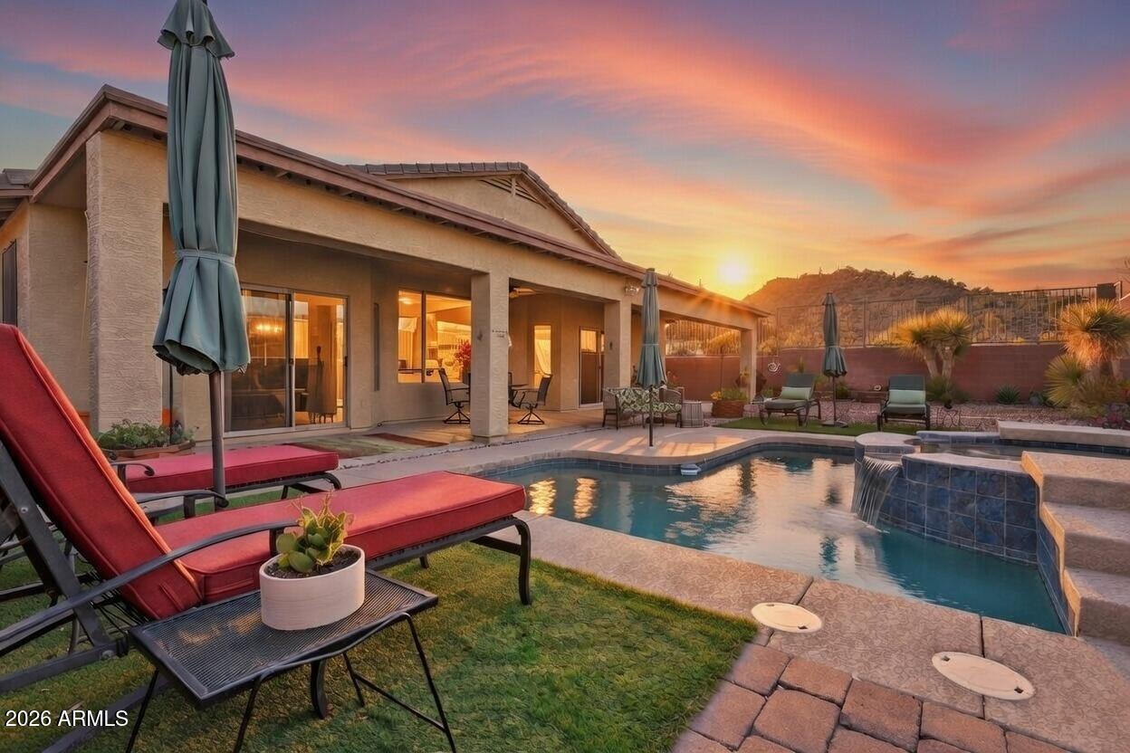 a swimming pool with outdoor seating and yard