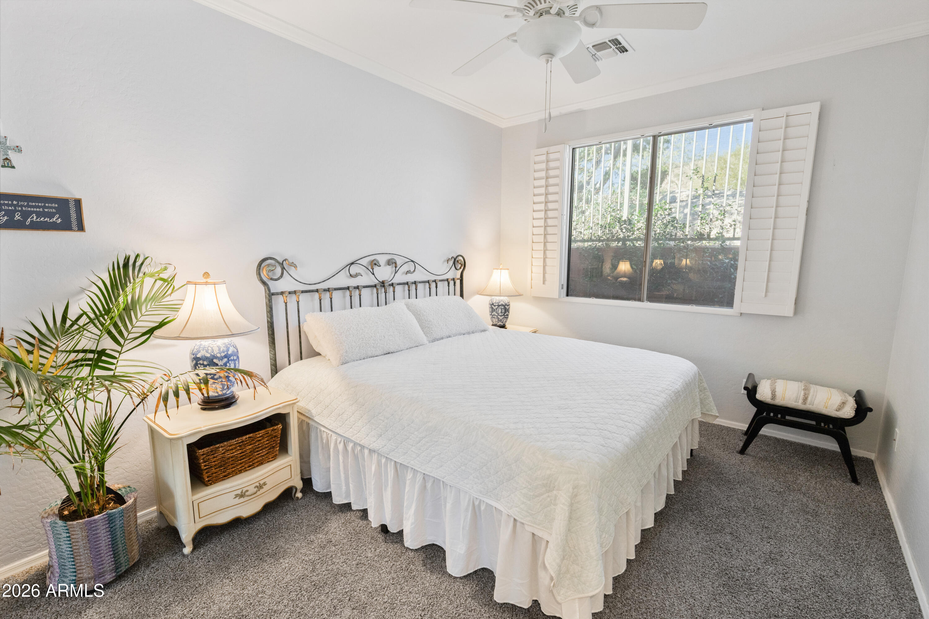 6530 West Bent Tree Drive Phoenix, AZ 85083 - Photo 24 of 42 a bedroom with a bed a chandelier and a window