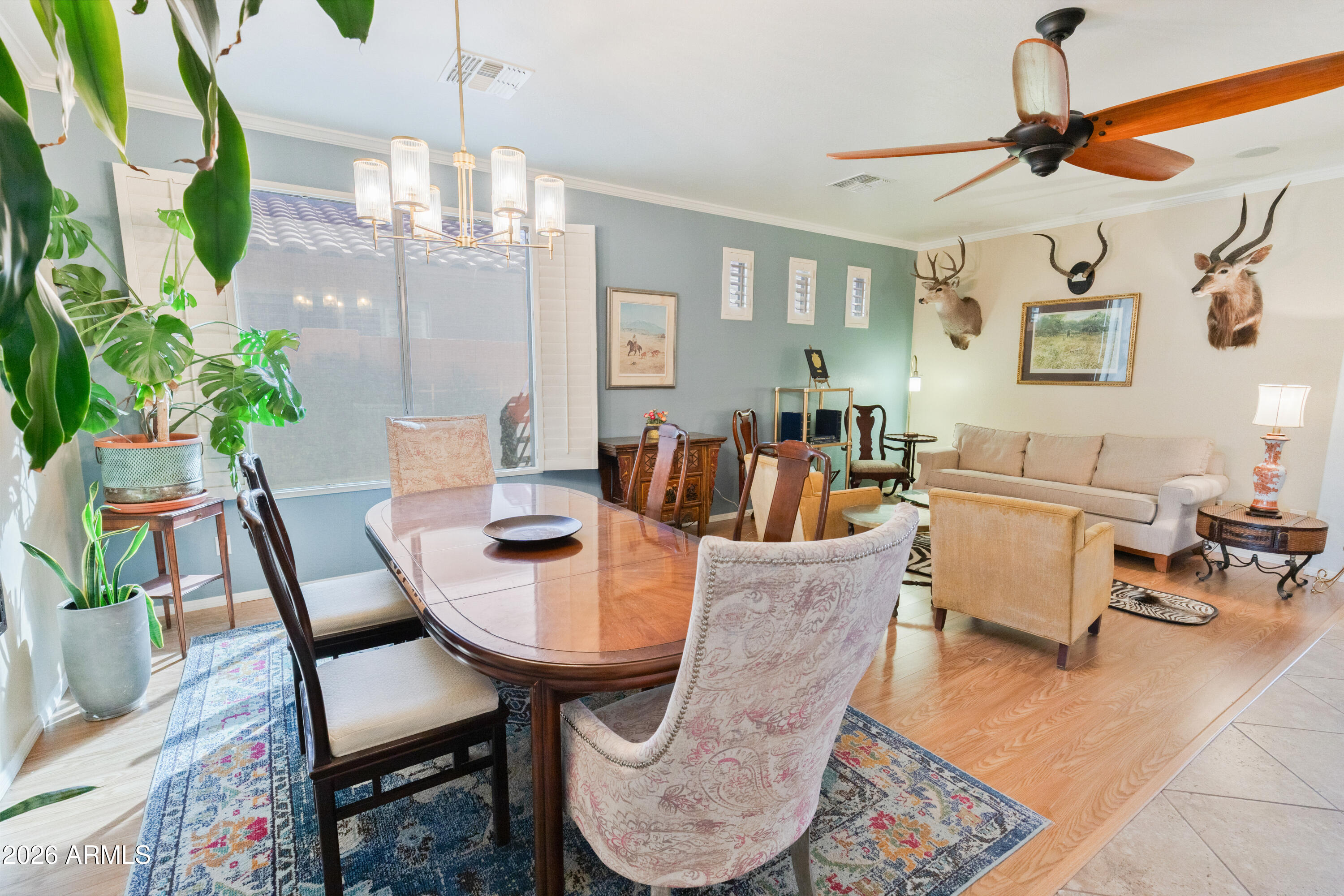 6530 West Bent Tree Drive Phoenix, AZ 85083 - Photo 28 of 42 a dining room with furniture a chandelier and wooden floor