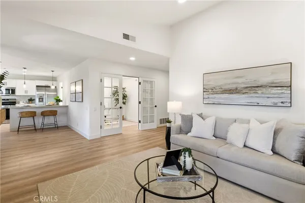 a living room with furniture and kitchen view