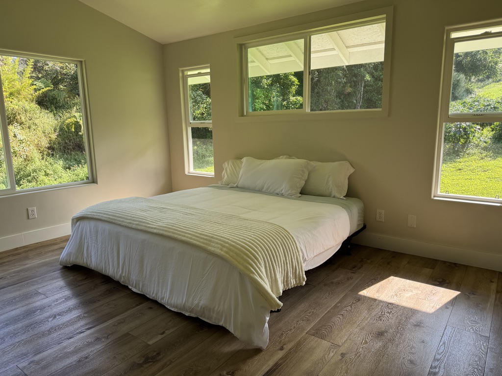 87-2854 Hawaii Belt Road Captain Cook, HI 96704 - Photo 8 of 30 a bedroom with a bed and window